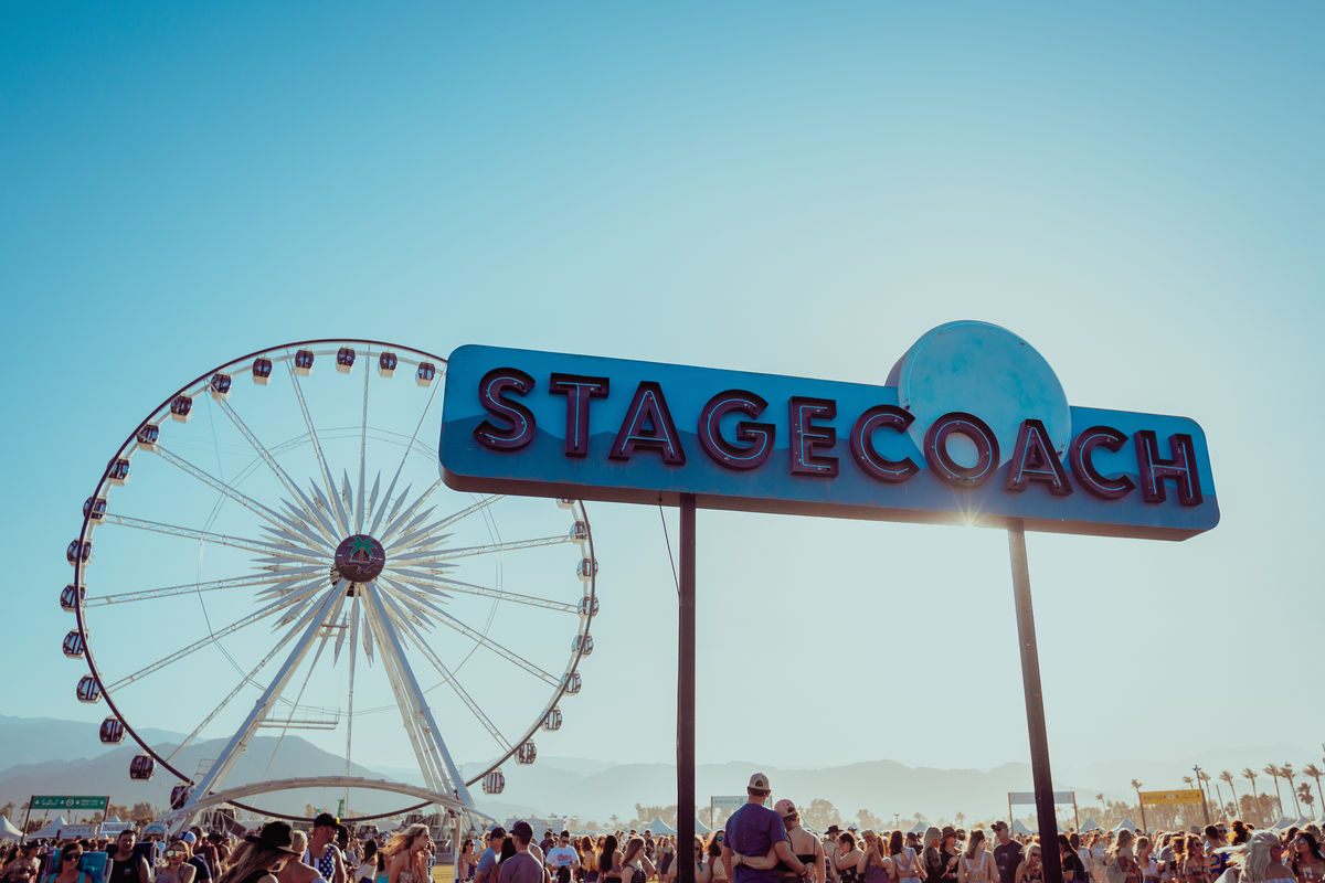 Stagecoach sign with ferris wheel in background