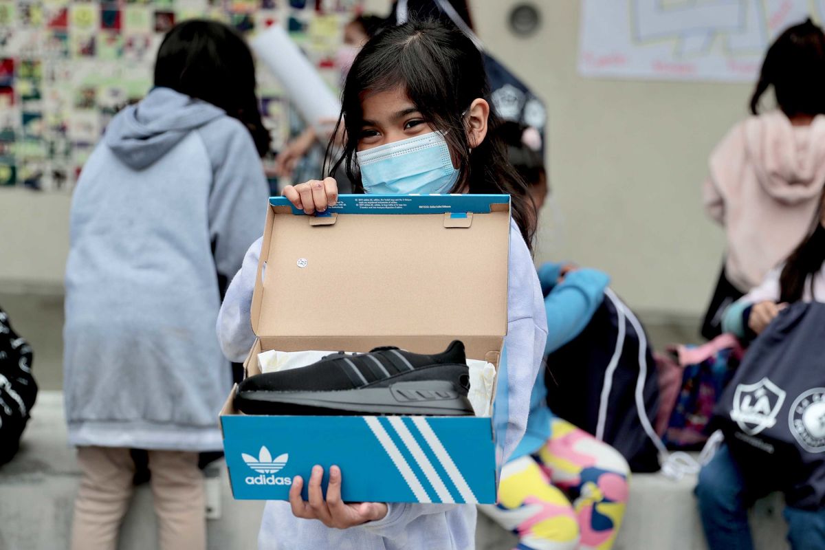 A student at Dolores Huerta Elementary School shows off her new pair of adidas during the LA Galaxy event. 