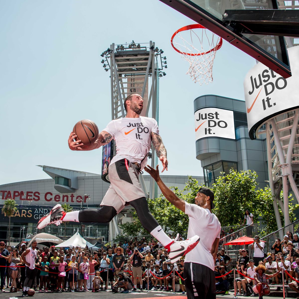A man is mid jump during his slam dunk attempt at the Nike Basketball Slam Dunk Contest at L.A. LIVE