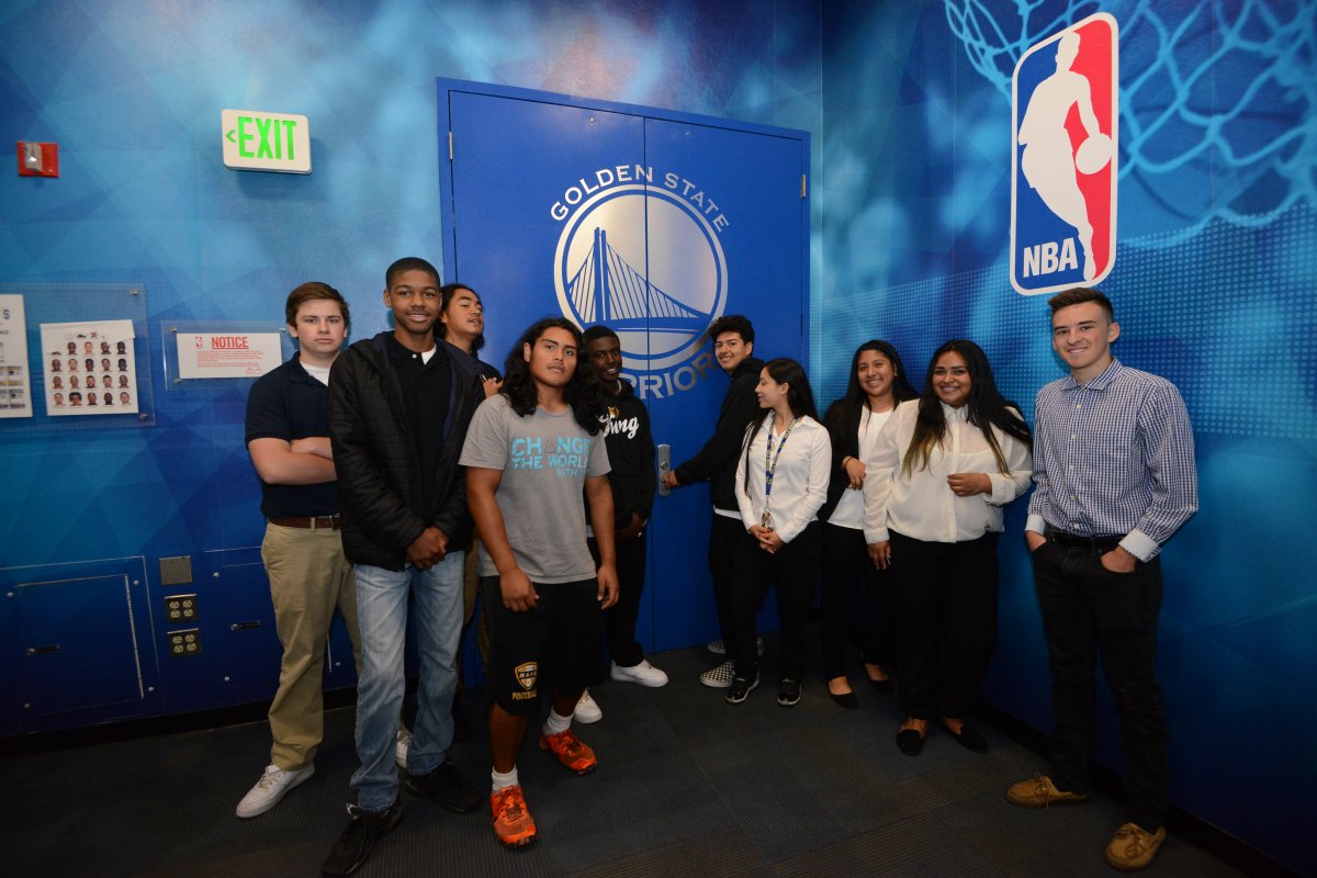 A group of young students outside the Golden State Warriors locker room