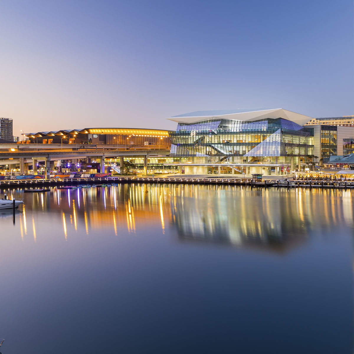 Exterior Image of International Convention Center Sydney at dusk on the water