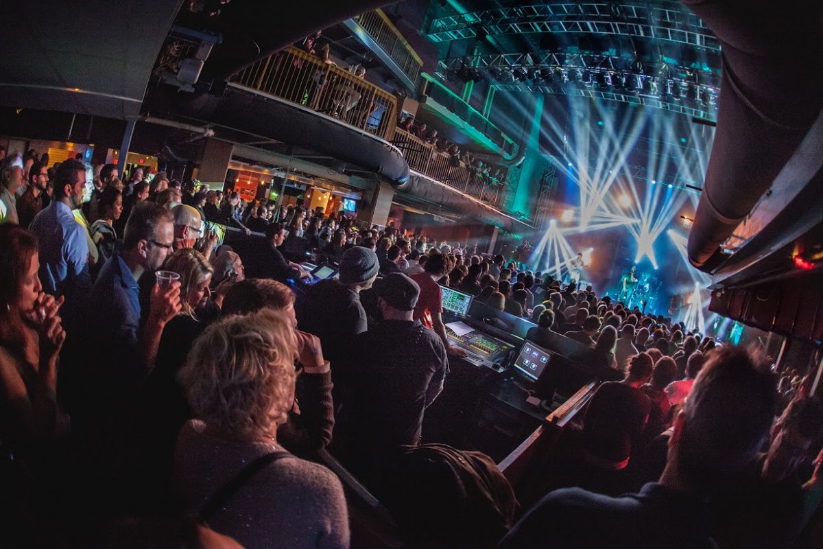 Interior image of Rams Head Live! behind the DJ booth during a concert looking on stage