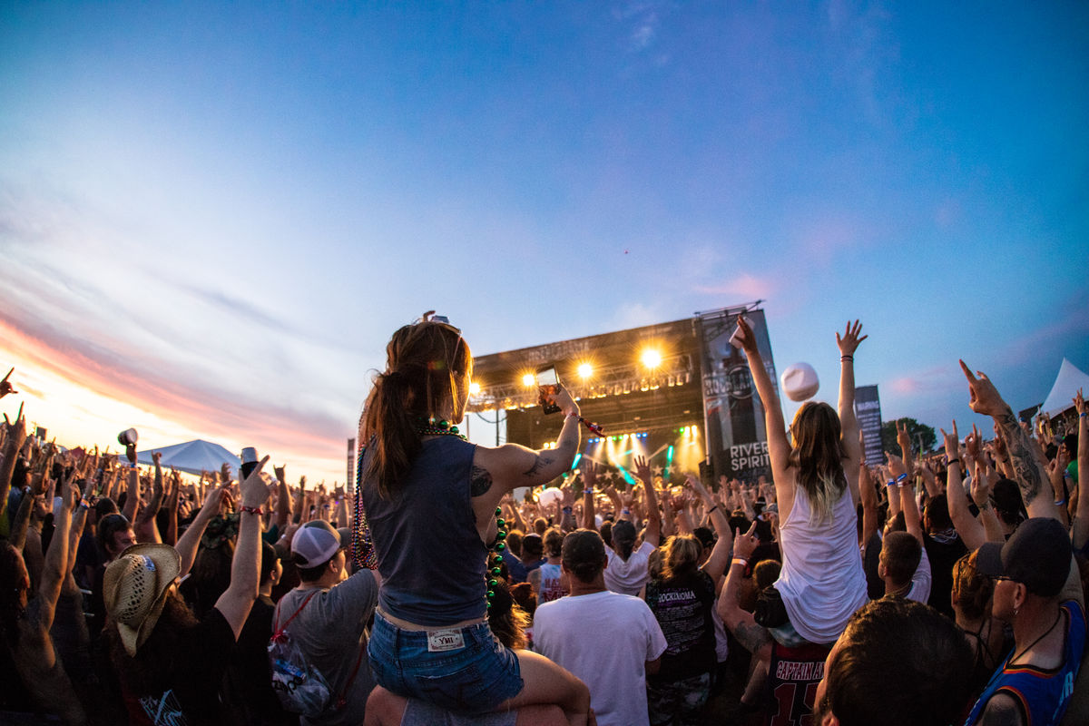 Image from crowd of girls on friends’ shoulders and stage in background