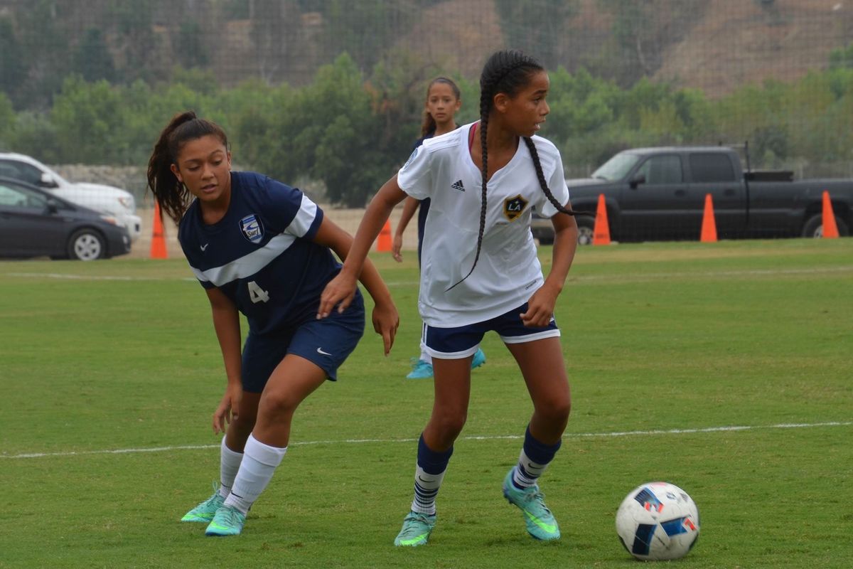An LA Galaxy Girls’ Academy player defends the ball during a scrimmage at a training field at StubHub Center. AEG’s LA Galaxy will invest $1 million to enhance Girls’ Academy training fields at StubHub Center in Carson, Calif.