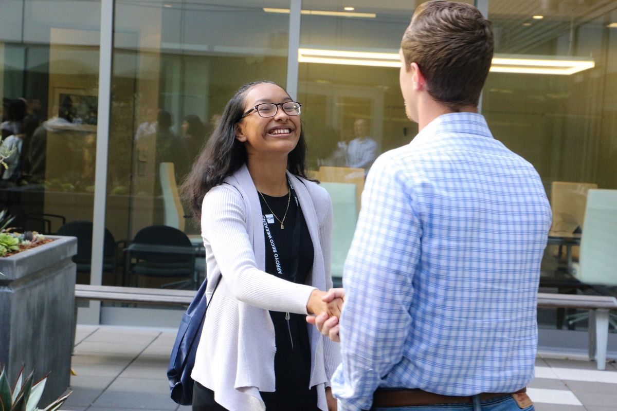 John Muir High School junior, Brenda Lopez shakes hands with her staff mentor for AEG’s Arroyo Seco Weekend Job Shadow Day at AEG’s global headquarters in downtown Los Angeles on April 26, 2017.