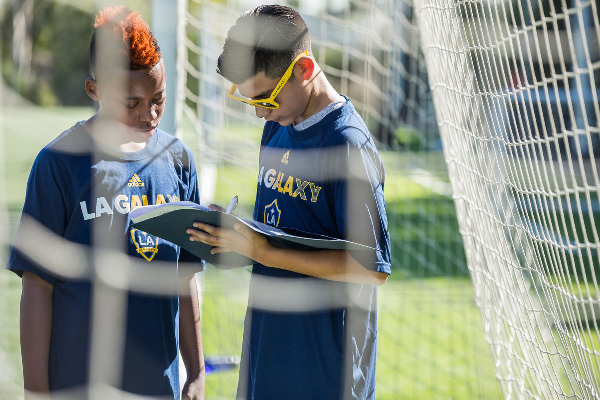 STEAM Curriculum Week: Two students from Inglewood Middle School log information into their notebook on the field at StubHub Center after learning Soccer, Technology, Engineering, Art and Math lessons from LA Galaxy and SNHU.