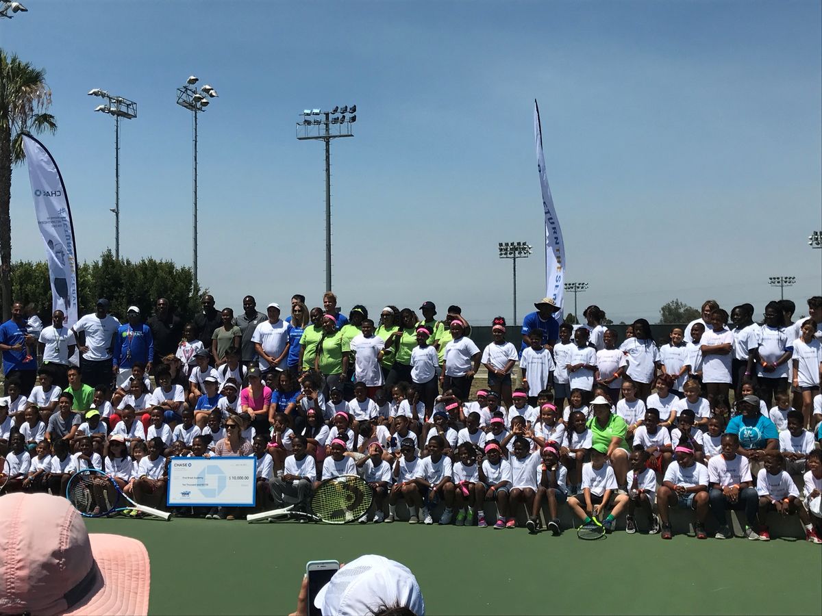 Participants and instructors from the Fourth Annual Chase Return the Serve Fun Day gather for a group photo at StubHub Center in Carson, Calif. 