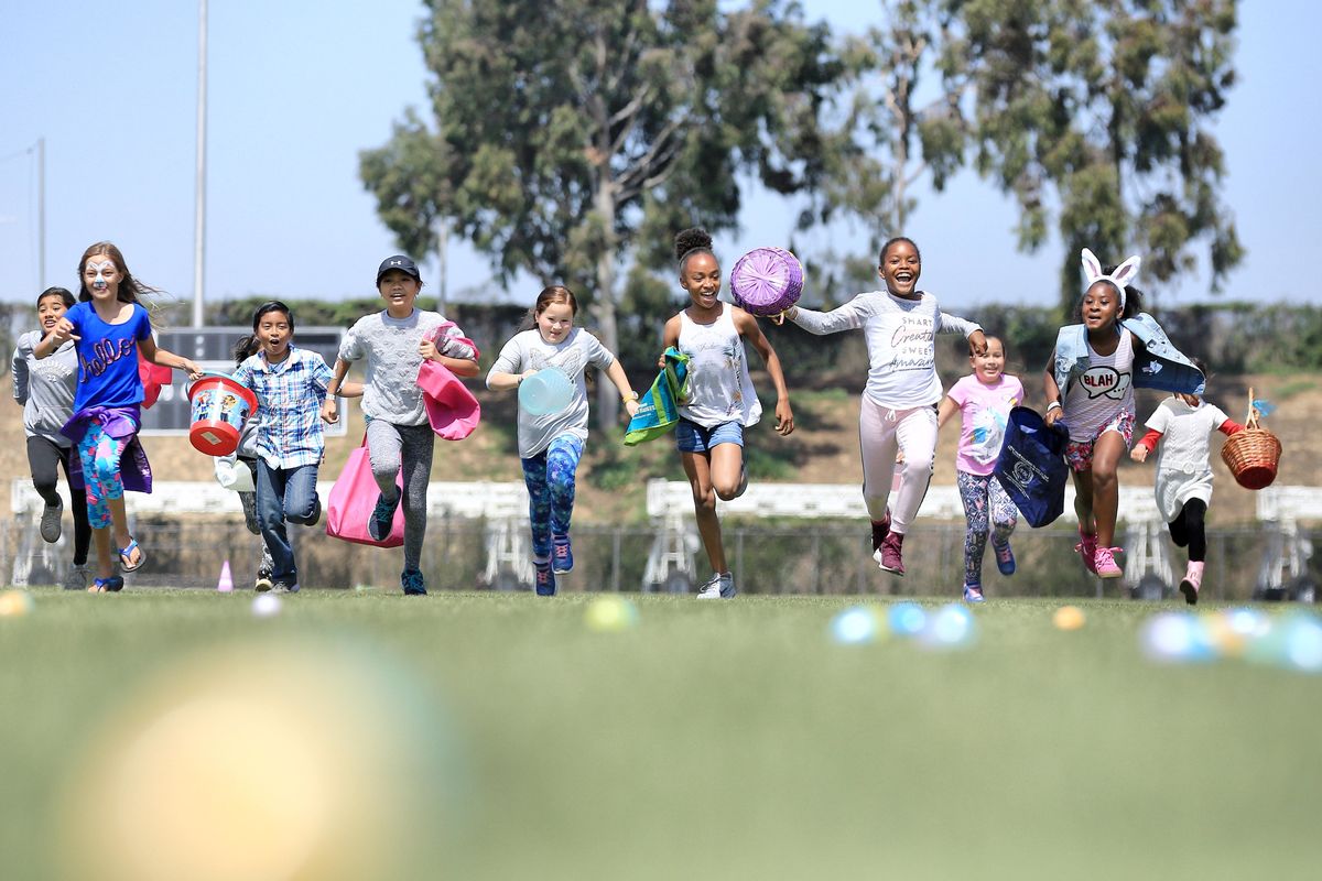 Children race to collect Easter eggs during the 12th Annual Easter Egg Hunt at StubHub Center hosted by the LA Galaxy Foundation and StubHub Center Foundation on March 30, 2018.