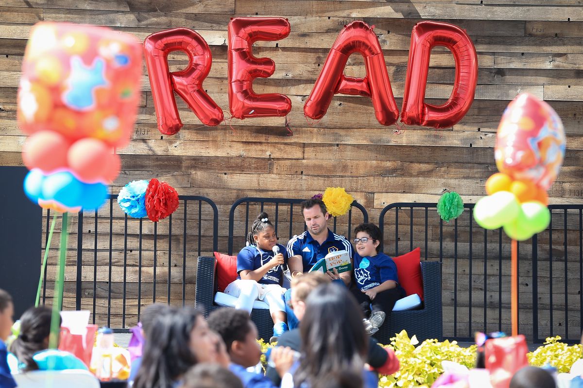 LA Galaxy President Chris Klein (center) reads Dr. Seuss’ Hop on Pop with elementary students at the Read Across America Day Celebration at StubHub Center on March 1, 2018.
