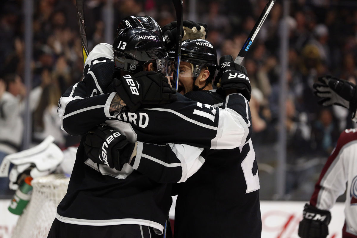 LA Kings players embrace after scoring a goal during a game at STAPLES Center.