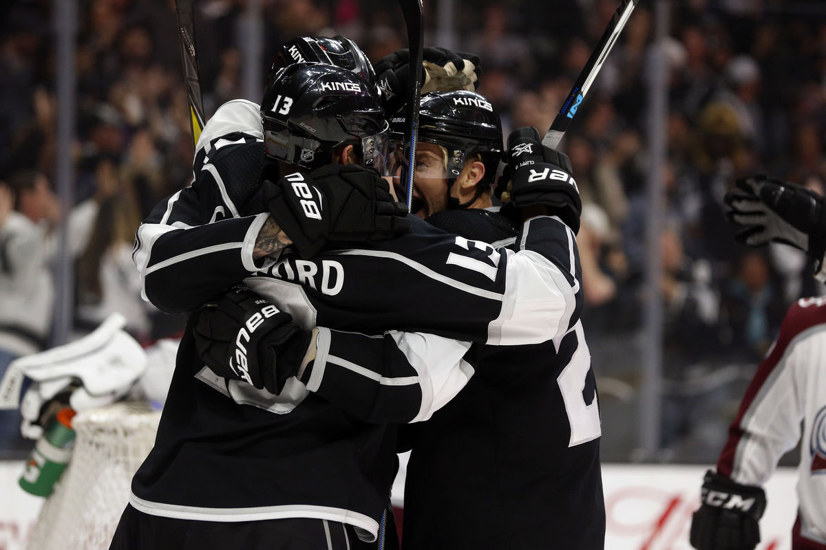 LA Kings players embrace after scoring a goal during a game at STAPLES Center. 