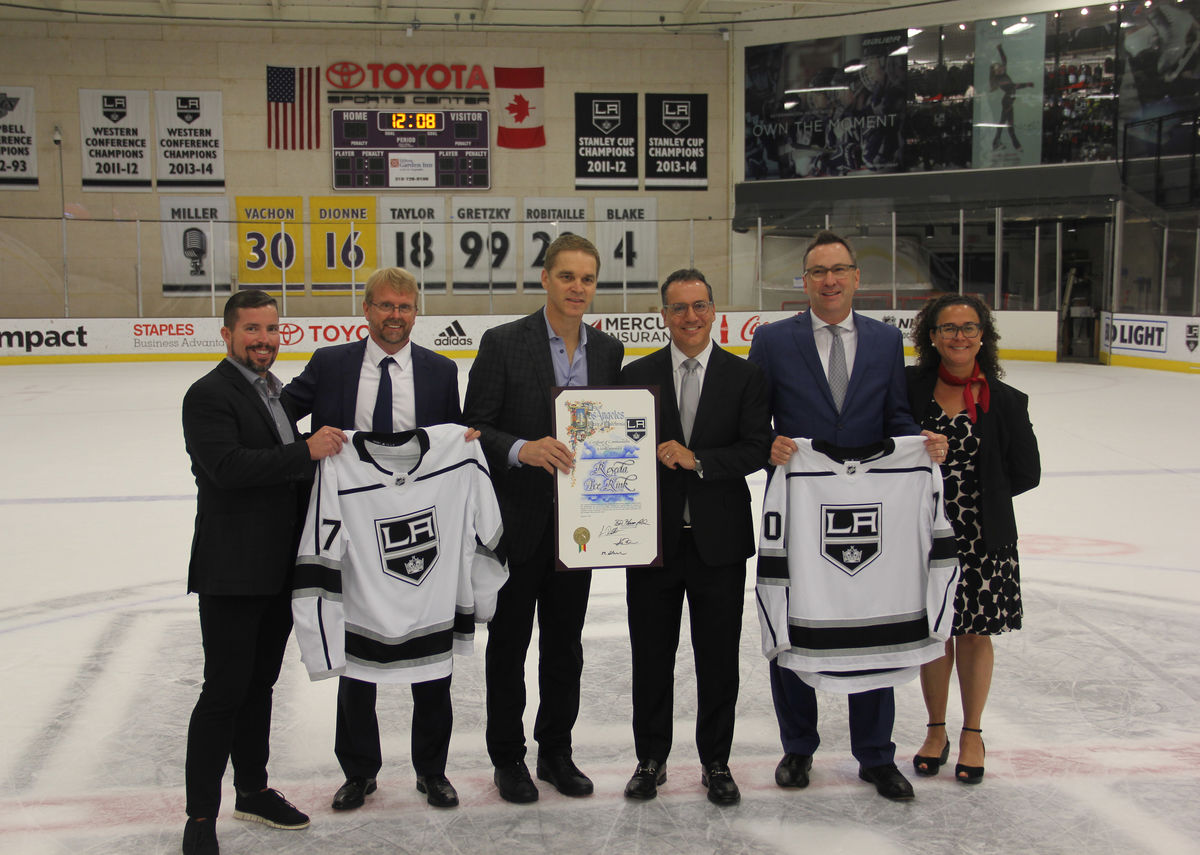 Los Angeles Kings President and Hockey Hall of Famer Luc Robitaille (left-center) and Councilmember Bob Blumenfield (right-center) pose for a photo on the ice of Toyota Sports Center with members of the City of Los Angeles and other officials to celebrate the public-private partnership between the LA Kings and the City of Los Angeles to build and manage the Reseda Ice Rink