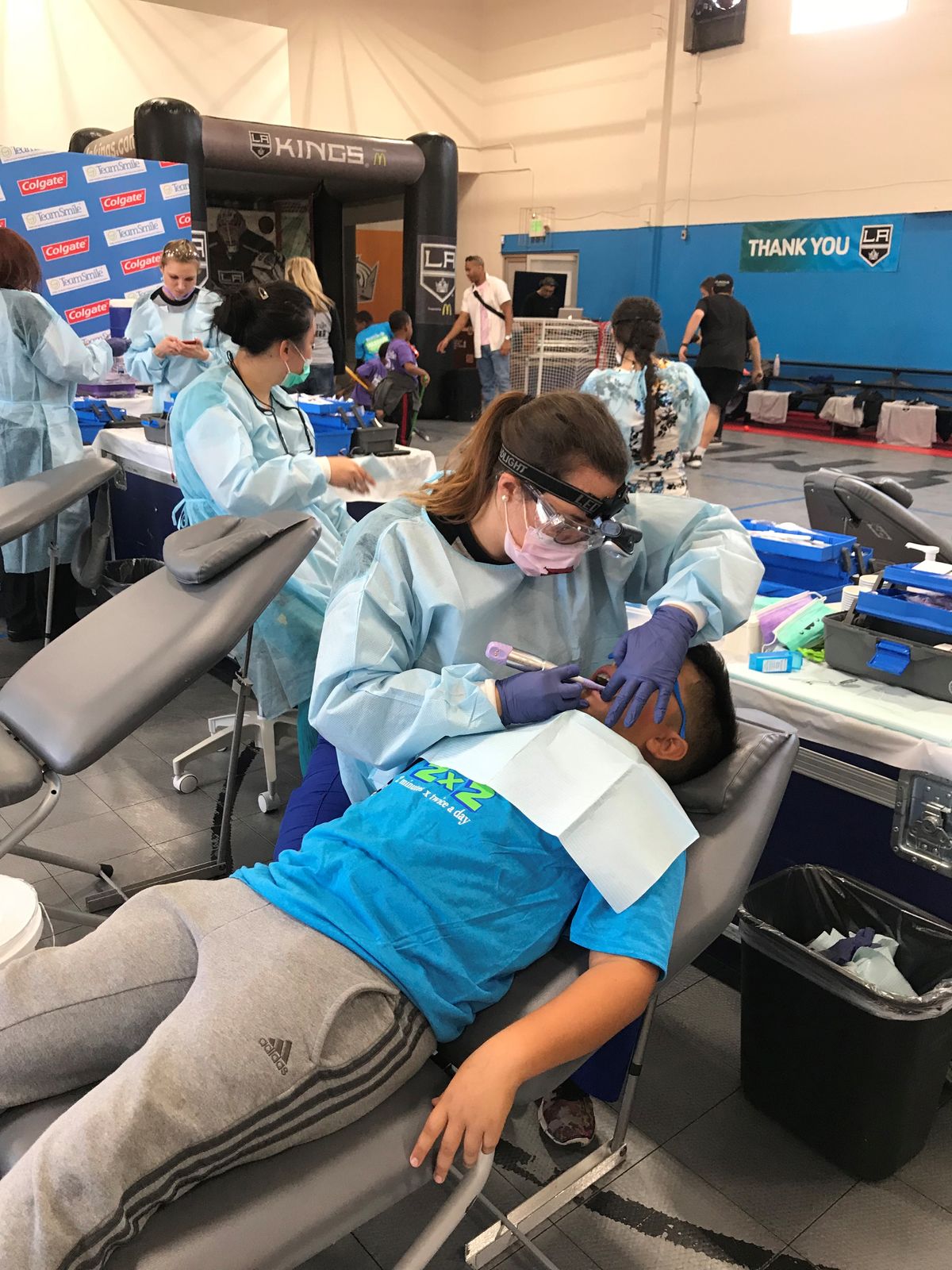 A dental technician from Team Smile provides a dental exam to a student at the Crenshaw Family YMCA in Crenshaw, Los Angeles.