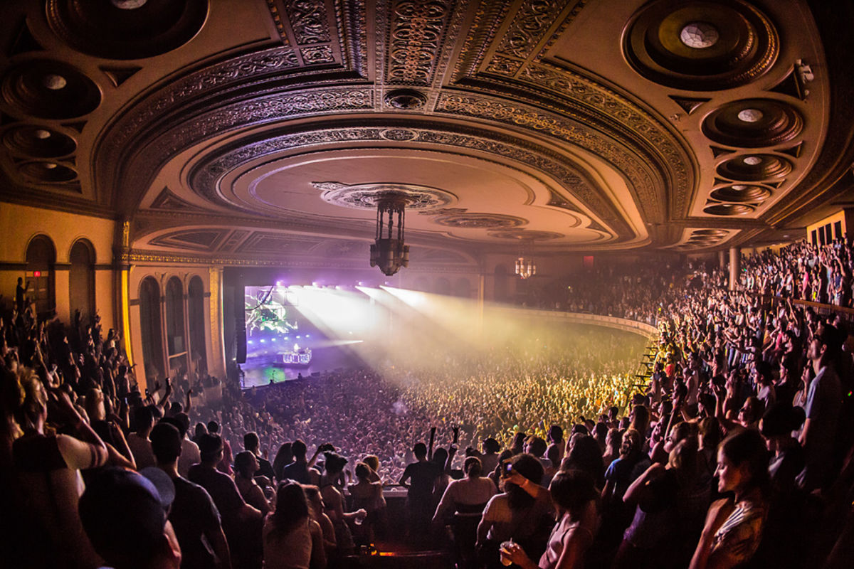 Fans in the balcony gaze onto the stage below during a concert at The Masonic Temple in Detroit