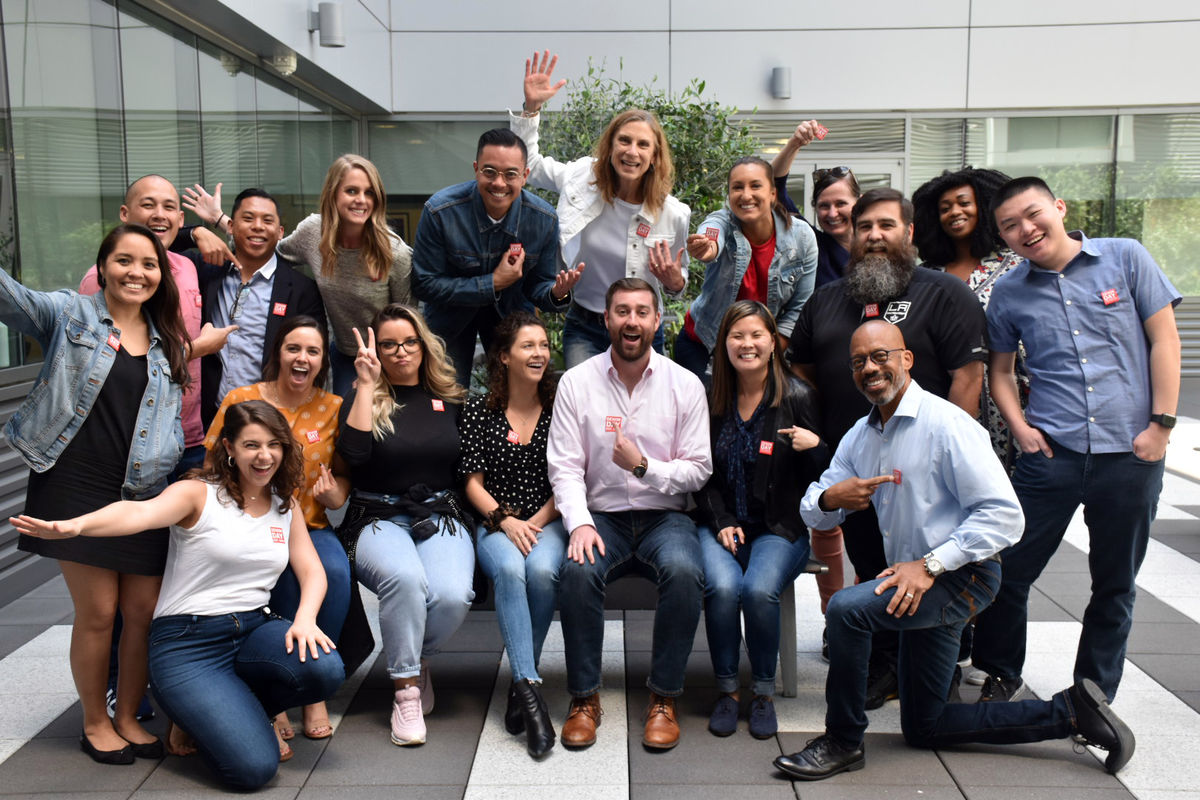 AEG employees wear denim and gather for a group photo for Denim Day, a campaign to raise awareness of sexual assault.