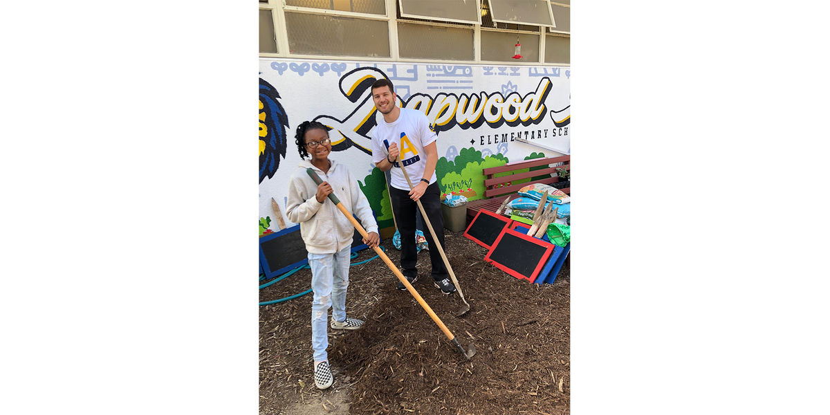 LA Galaxy Staff and a student from Leapwood Avenue Elementary work in the school's garden during an Earth Month event. 
