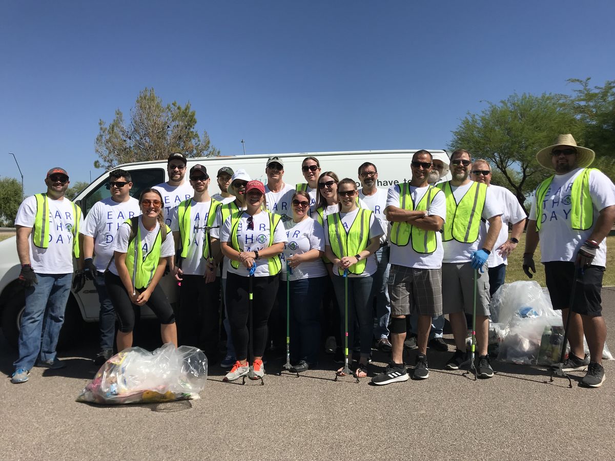 Gila River Arena employees gather for a group photo following picking up trash in two parks around the arena on Earth Day.