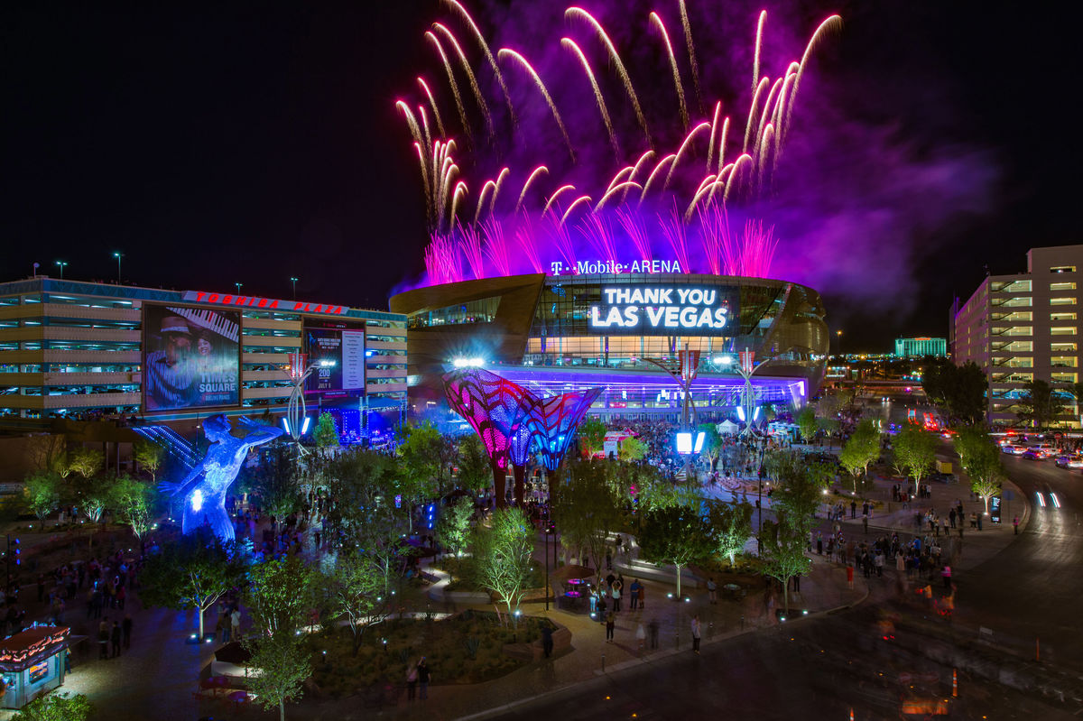 T-Mobile Arena in Las Vegas at night with fireworks above. 