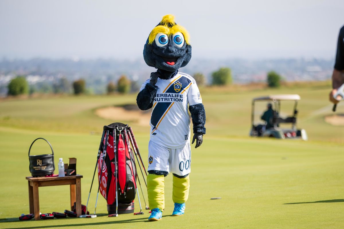 LA Galaxy mascot Cozmo walks the green with a golf bag during the LA Galaxy Golf Tournament. 