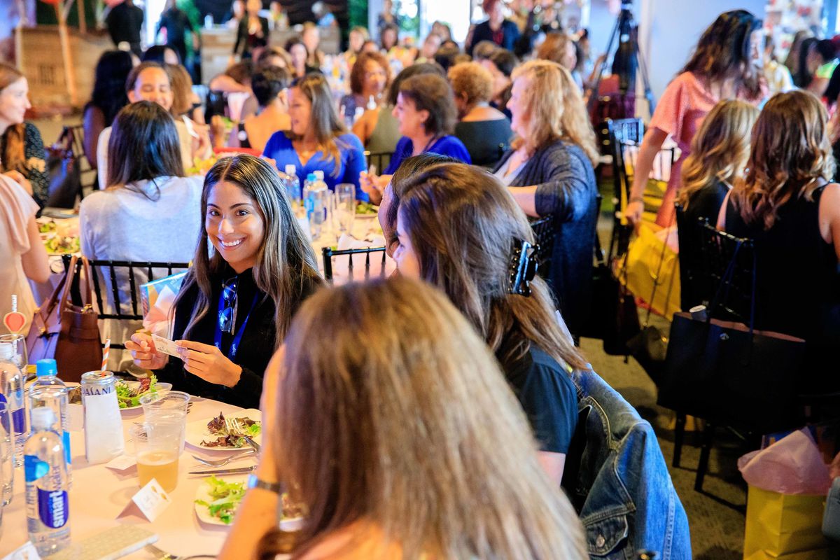 Female executives sit at tables and network and discuss issues and trends affecting women working in the entertainment industry during the Sixth Annual Women in Entertainment Luncheon.
