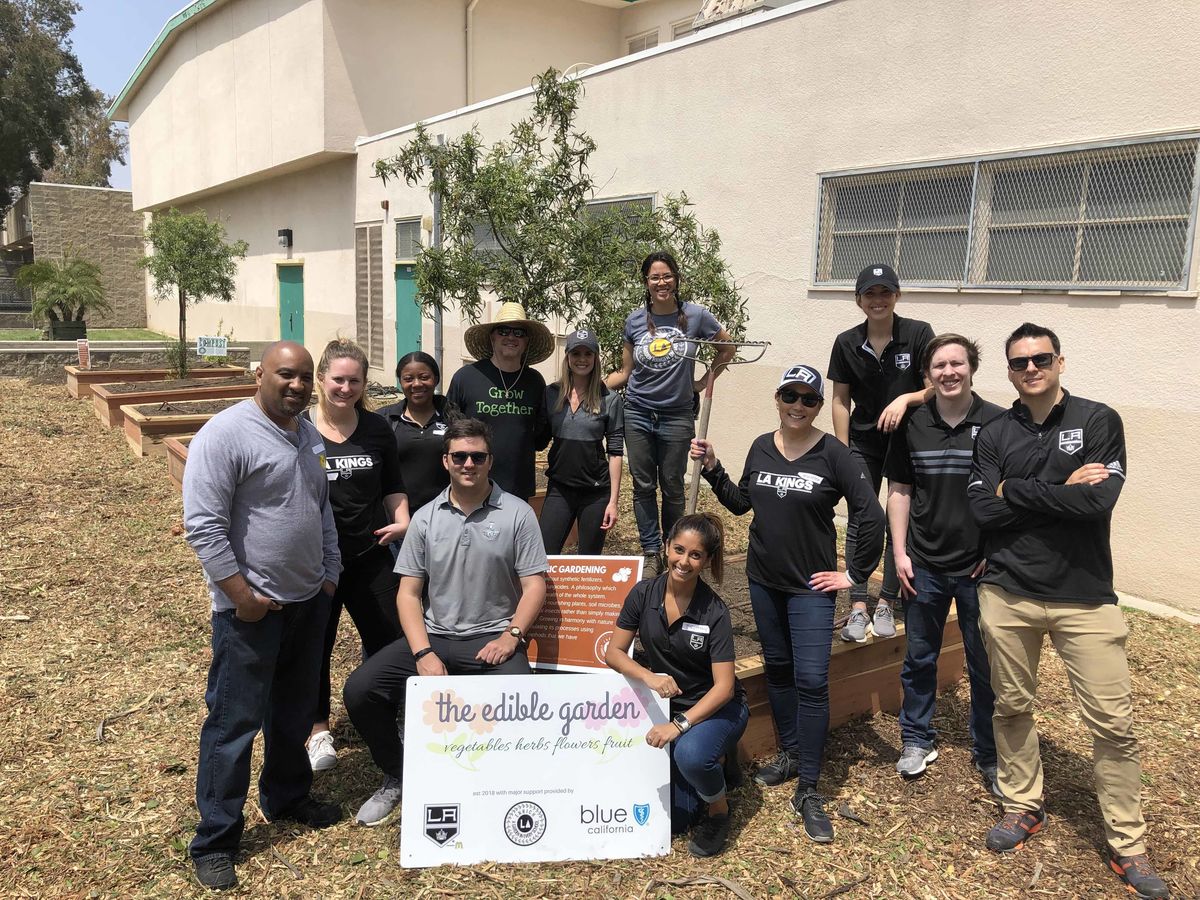 Member of the LA Kings staff pose for a photo following the completion of a garden build at an elementary school in Los Angeles.