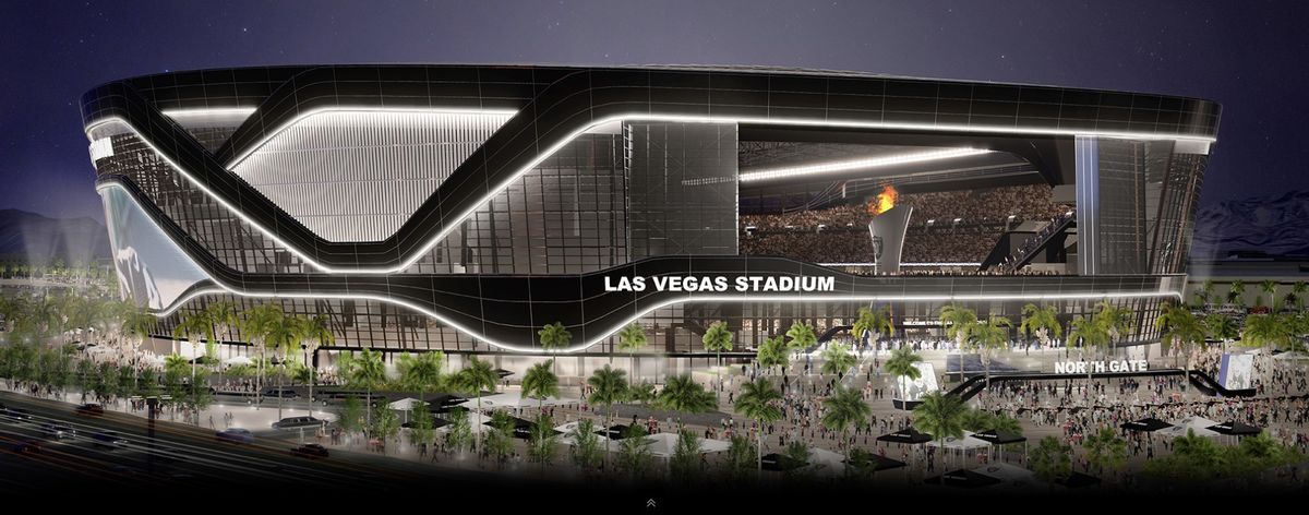 A rendering of the Las Vegas Stadium depicts the stadium at night illuminated by lights with trees surrounding the entrance. 