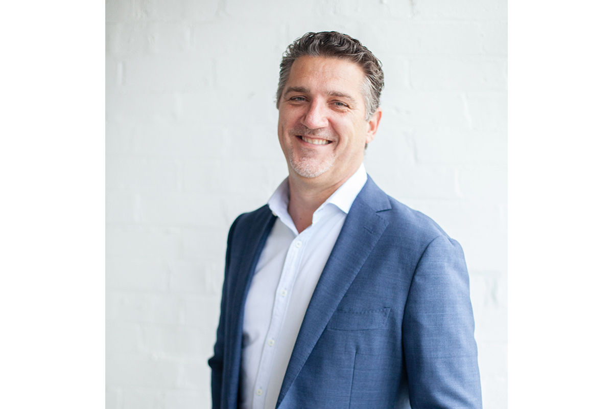 Headshot of Matthew Lazarus-Hall in a white shirt and blue jacket.