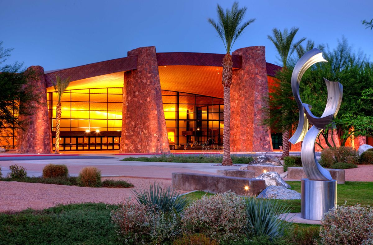 The Palm Springs Convention Center is illuminated at dusk