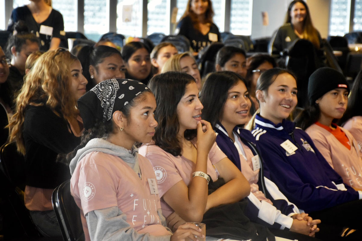 High school female athletes laugh in the audience during a panel at the second Annual LA Galaxy High School Girls' Summit at Dignity Health Sports Park.