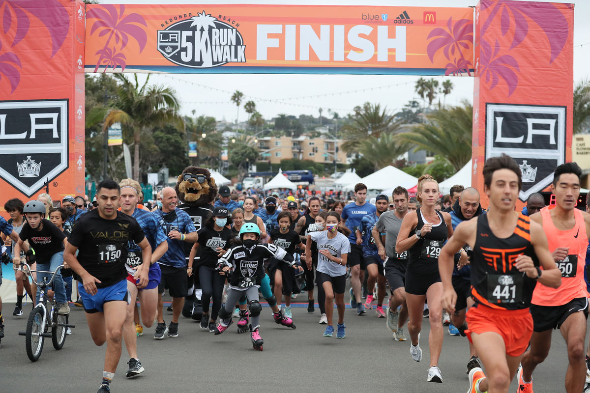 A sea of runners and community members take off under the LA Kings banner during the LA Kings 5K in Redondo Beach.