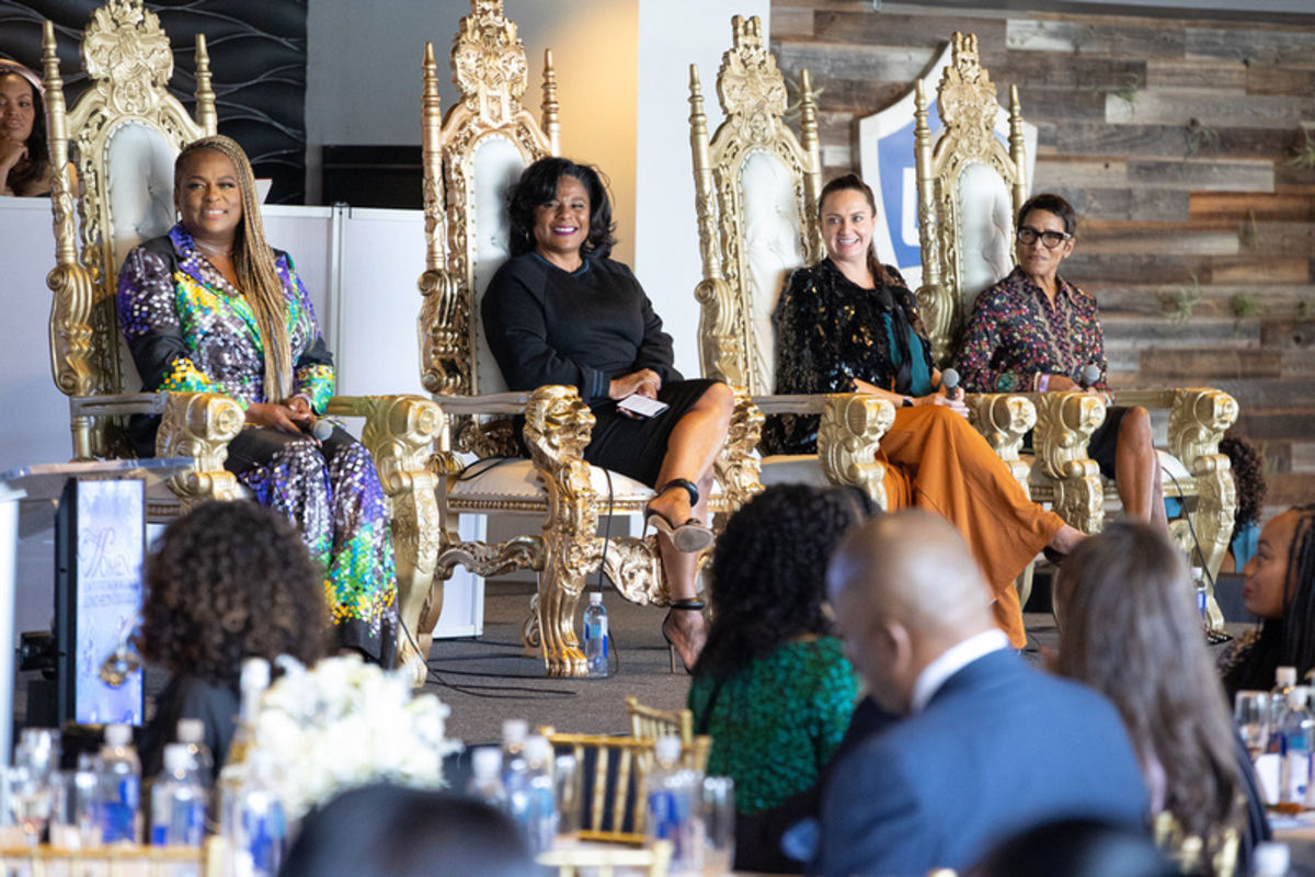 Panelists at the Women in Entertainment Luncheon at Dignity Health Sports Park smile while looking at the moderator during the panel discussion.