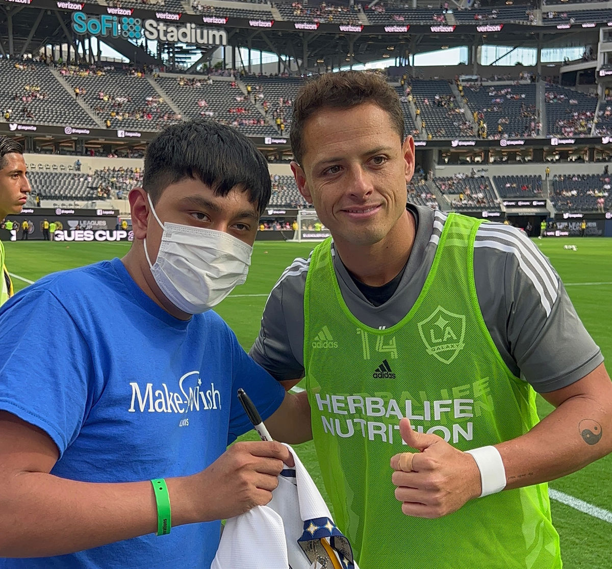 LA Galaxy's Javier "Chicarito" Hernandez poses on the pitch with Richey, a 17-year old Make A Wish recipient