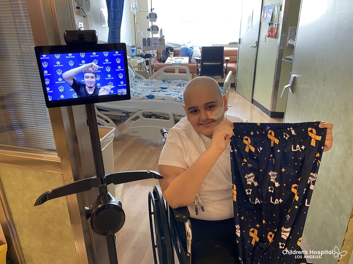 A patient at CHLA receives the customized PJ pant during the LA Galaxy visit.