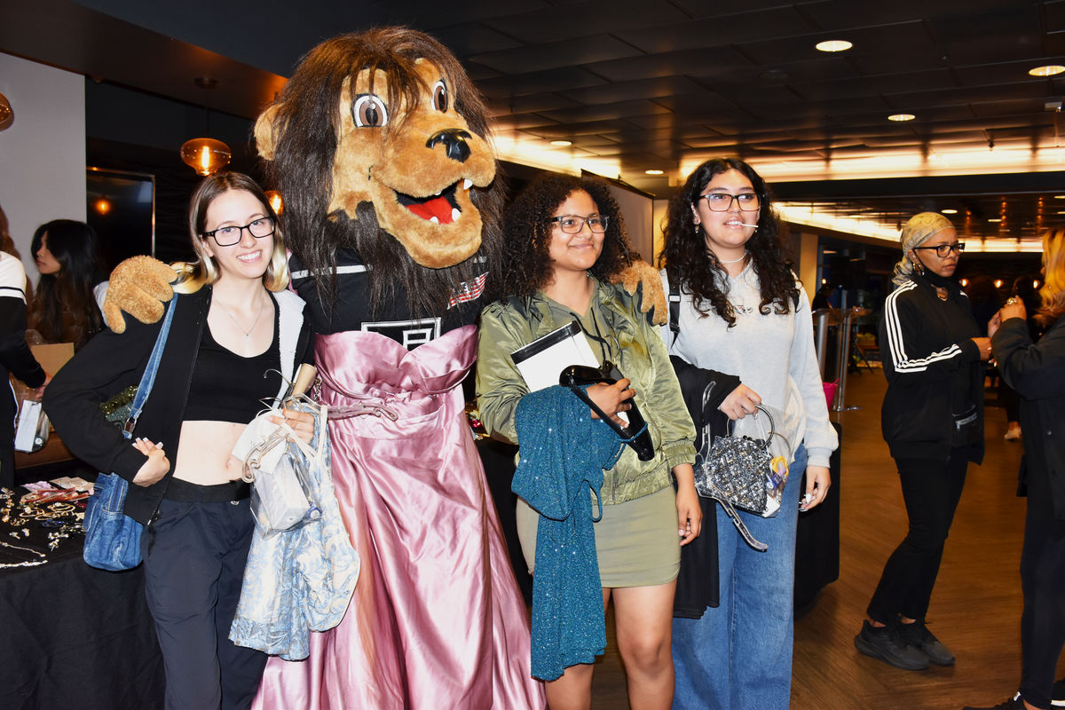 Attendees pose with LA Kings mascot Bailey at the prom dress giveaway pop-up at Dignity Health Sports Park in Carson, CA.