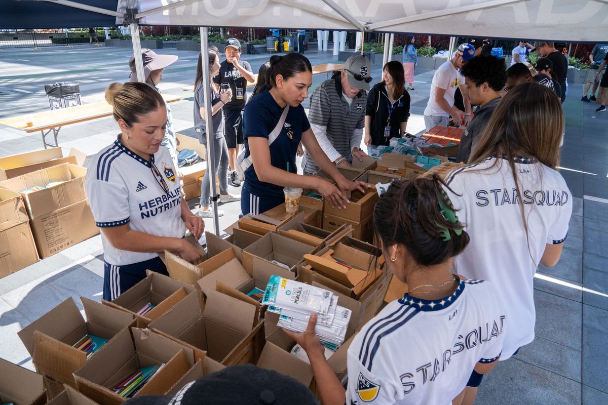 Employees from AEG, the LA Kings and the LA Galaxy gathered at L.A. LIVE in Downtown Los Angeles to pack 3,500 backpacks.