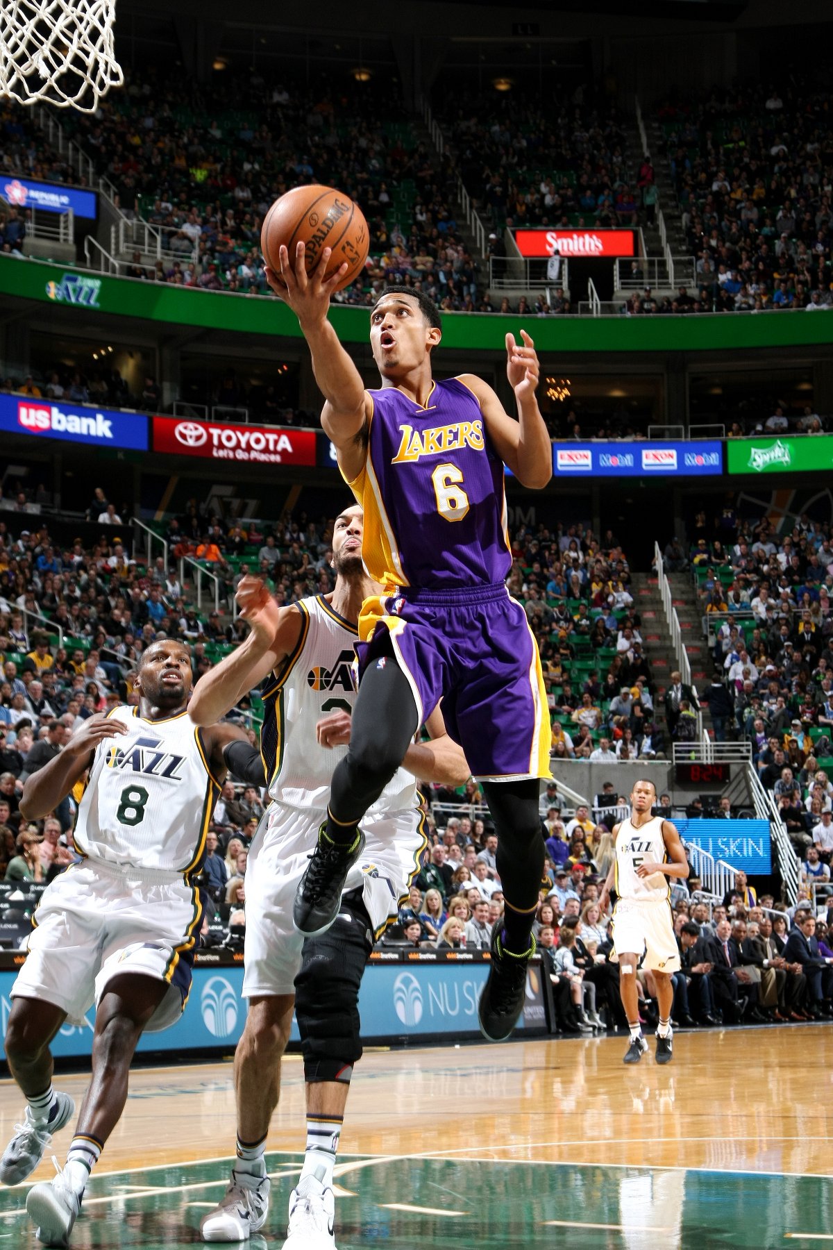 Lakers player jumping to score a basket