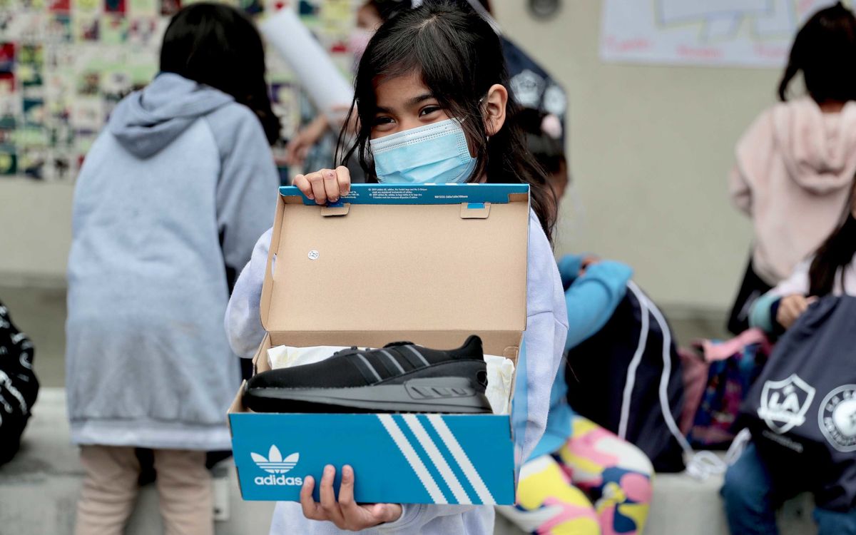 A student at Dolores Huerta Elementary School shows off her new pair of adidas during the LA Galaxy event. 